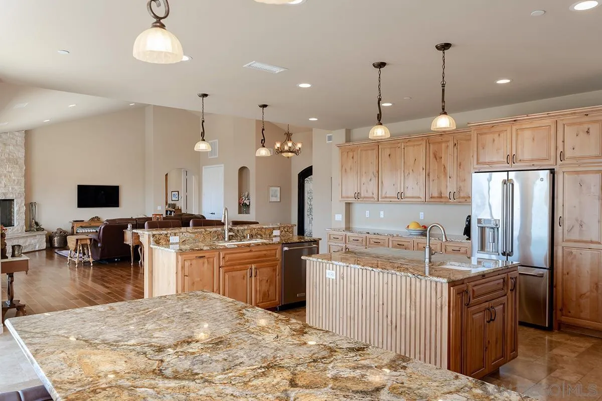 19840 7th Place Escondido, CA 92029 - Photo 19 of 49 a kitchen with stainless steel appliances kitchen island granite countertop a sink stove and refrigerator