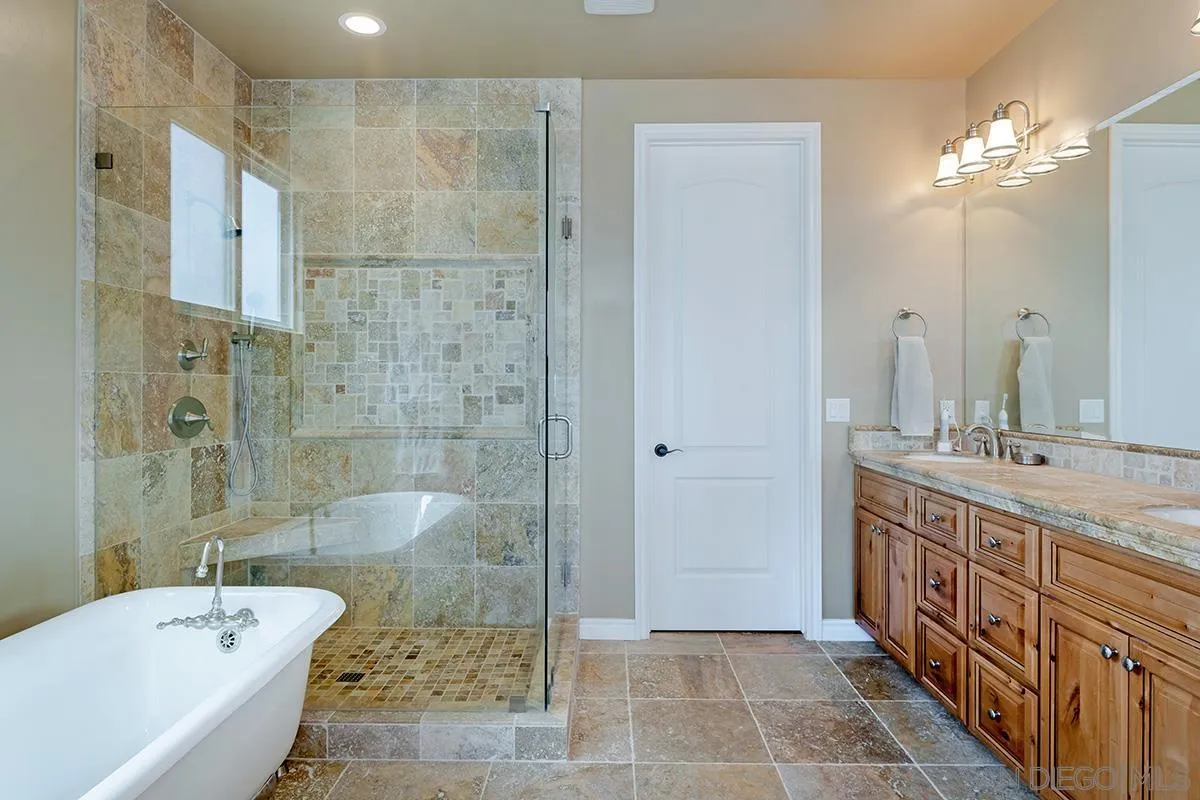 19840 7th Place Escondido, CA 92029 - Photo 30 of 49 a bathroom with a double vanity sink large mirror and shower