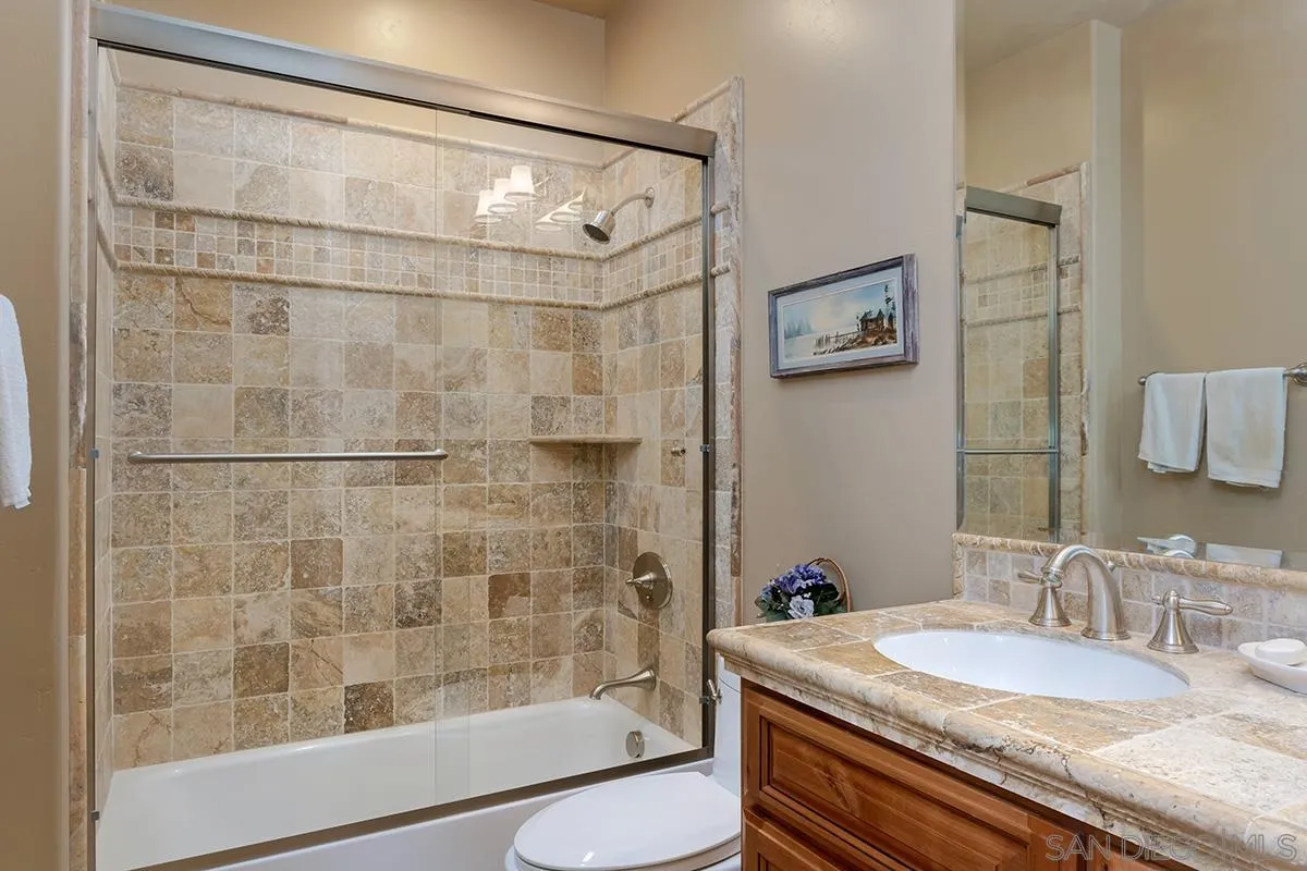 19840 7th Place Escondido, CA 92029 - Photo 36 of 49 a bathroom with a granite countertop shower sink and mirror