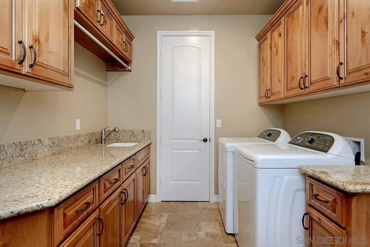 19840 7th Place Escondido, CA 92029 - Photo 37 of 49 a utility room with granite countertop a sink a washer and dryer