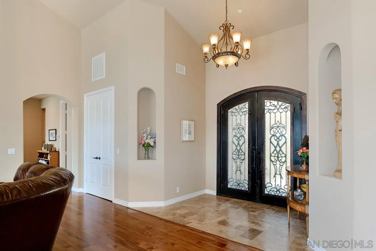 19840 7th Place Escondido, CA 92029 - Photo 5 of 49 a view of a hallway with wooden floor and a chandelier