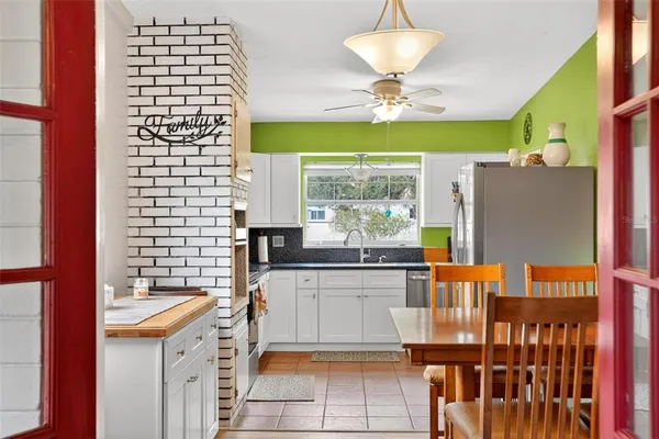 a kitchen with a sink a refrigerator and window