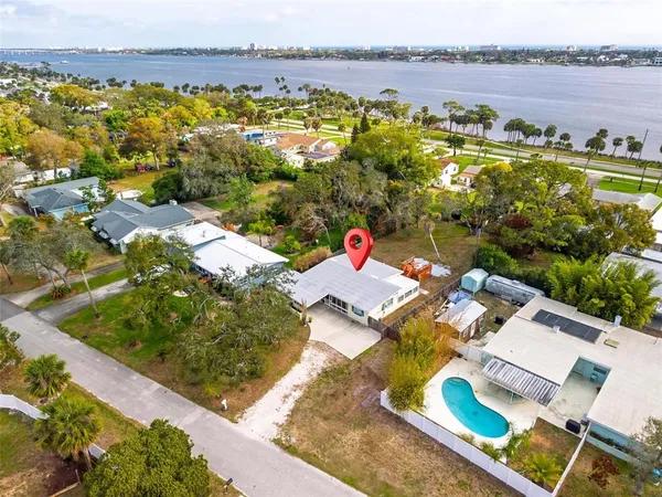 a view of a house with a backyard and a table and chairs