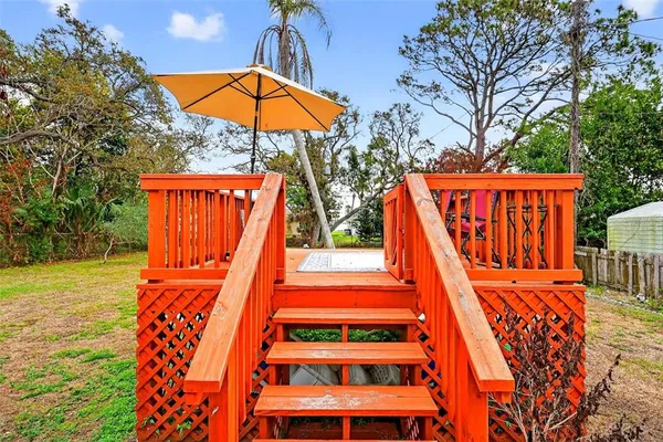 a view of a roof deck with furniture