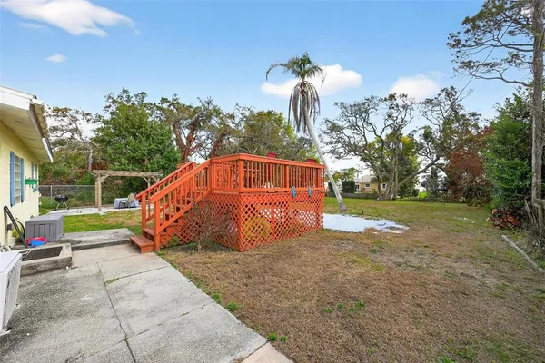 a backyard of a house with lots of green space and fountain