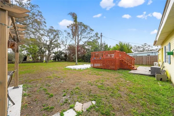 a view of a yard with furniture and garden