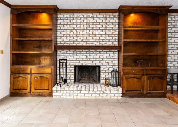 a view of a livingroom with an empty space and a fireplace