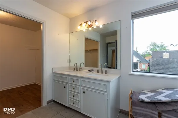 a bathroom with a double vanity sink and a mirror