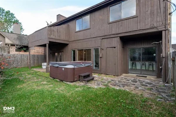 a backyard of a house with yard and outdoor seating