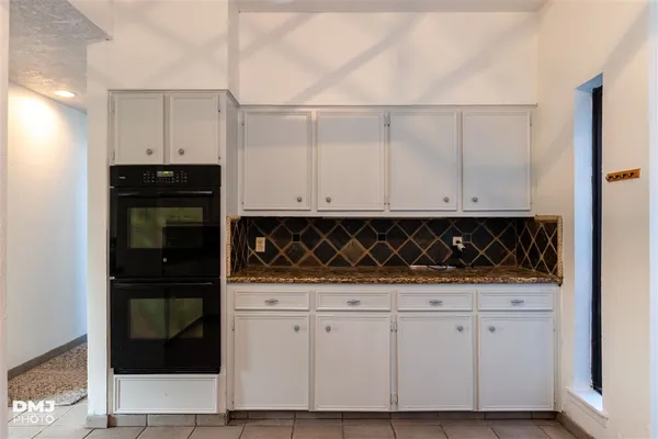 a close view of a stove top oven and cabinets