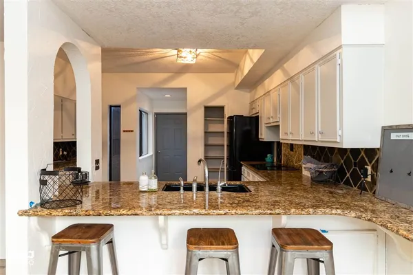 a kitchen with stainless steel appliances granite countertop a sink and cabinets