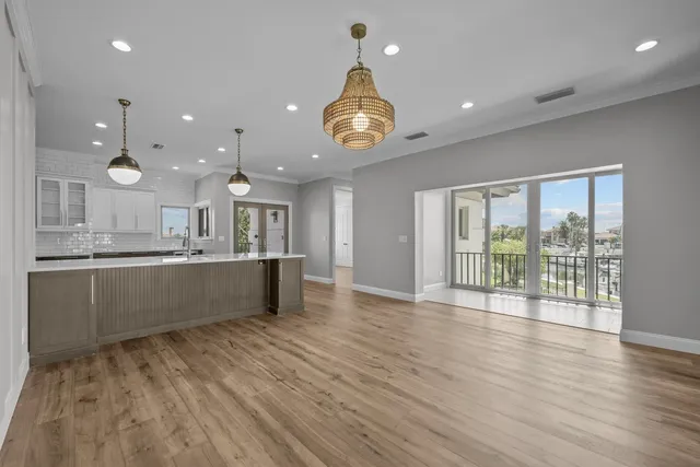 a view of a livingroom with wooden floor and a ceiling fan