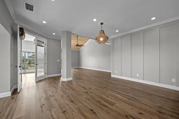 a view of a livingroom with a ceiling fan a fireplace a ceiling fan and wooden floor