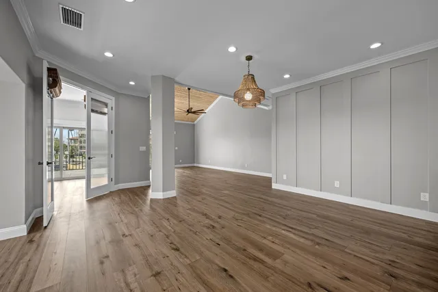 a view of a livingroom with a ceiling fan a fireplace a ceiling fan and wooden floor