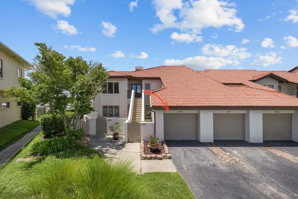 a backyard of a house with table and chairs