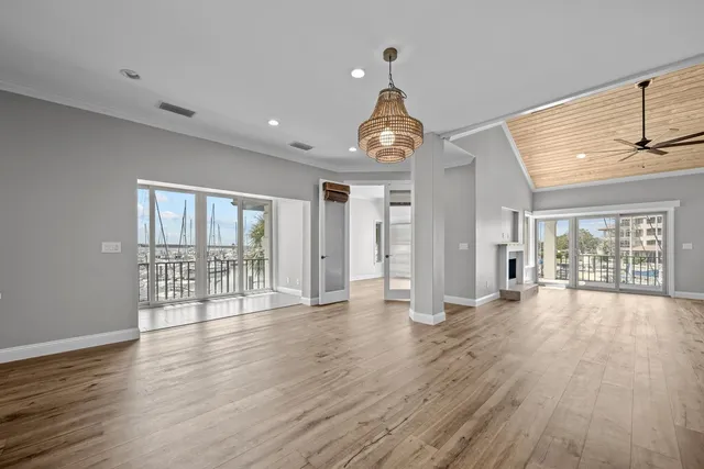 a view of empty room with wooden floor and fireplace