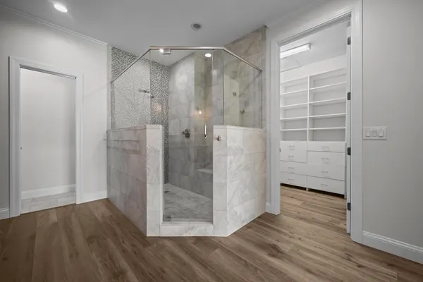 a bathroom with a granite countertop double vanity sink and mirror