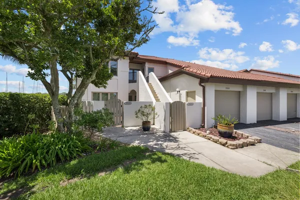 a view of a chair and table in backyard of the house