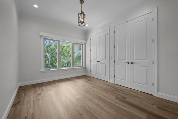 a bathroom with a granite countertop sink mirror vanity and toilet