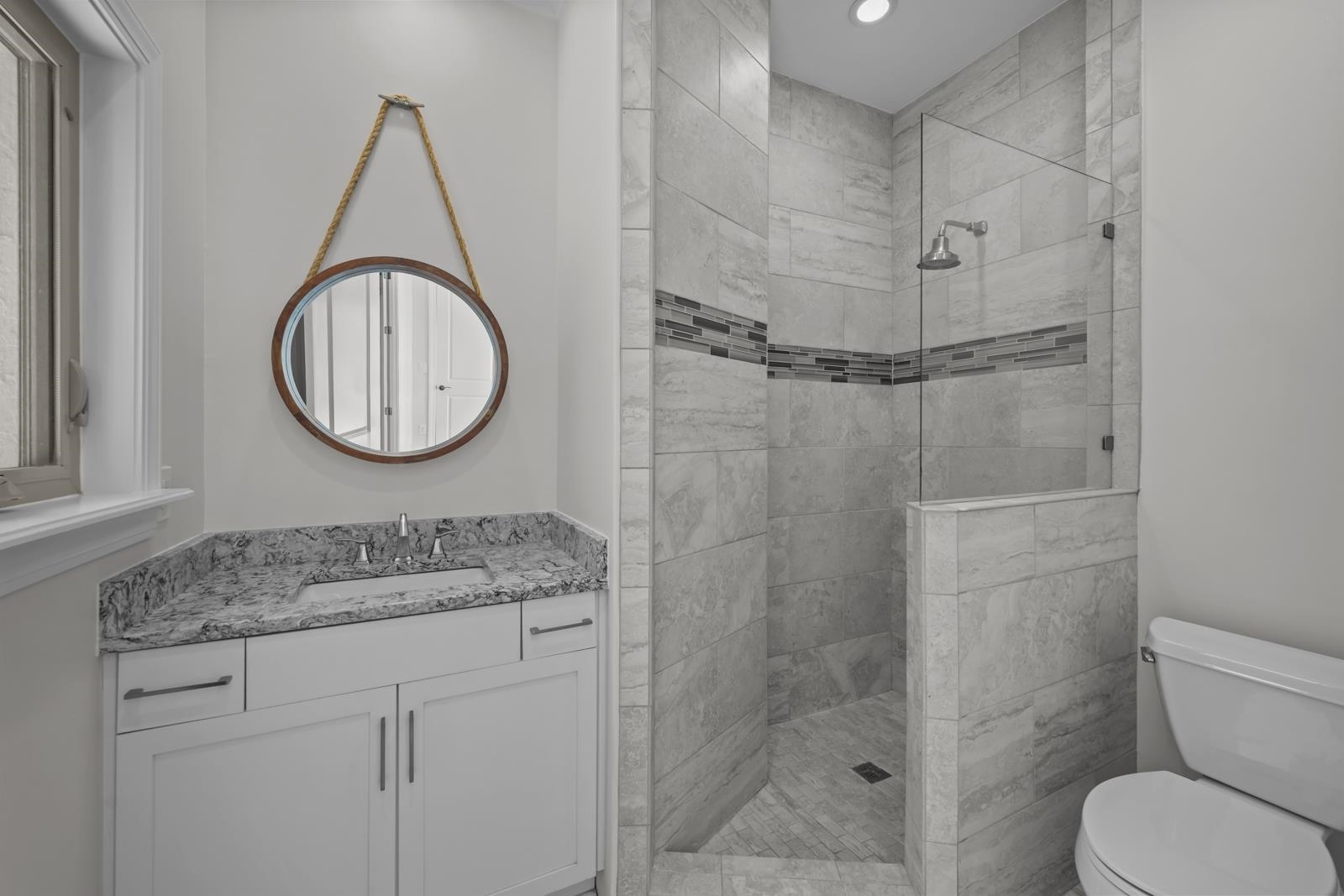 3505 Harbor Drive St. Augustine, FL 32084 - Photo 37 of 55 a bathroom with a granite countertop sink mirror vanity and toilet