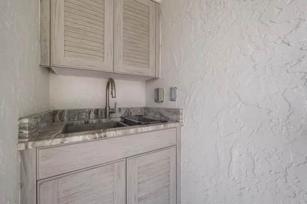 a view of staircase with lots of frames on wall and a window