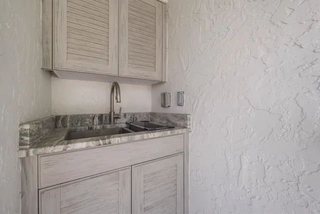 a view of staircase with lots of frames on wall and a window