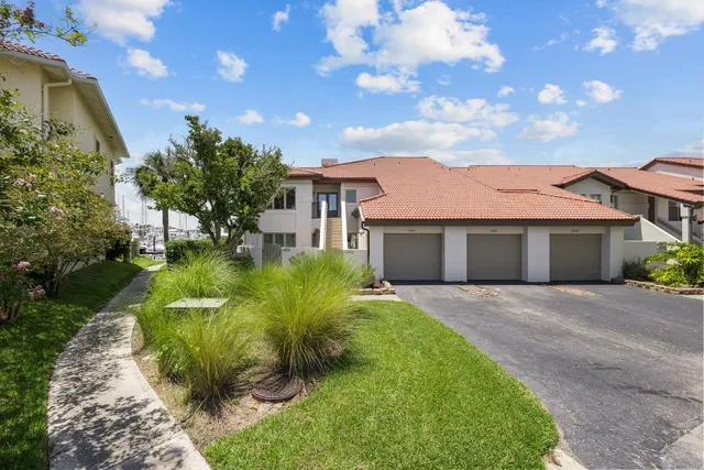 an aerial view of residential houses with outdoor space and swimming pool