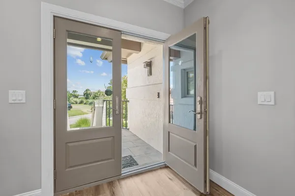 a large kitchen with stainless steel appliances a large counter top a sink a refrigerator and a window