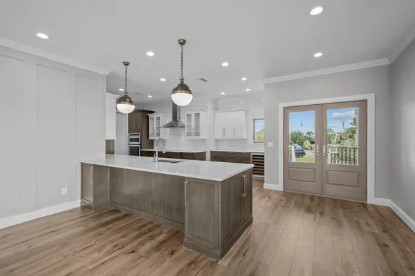 a large kitchen with kitchen island a sink stainless steel appliances and cabinets