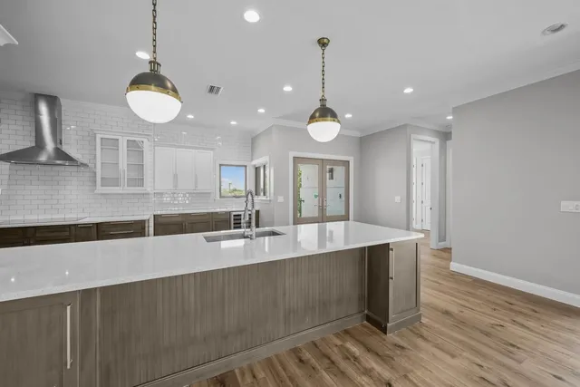 a large kitchen with stainless steel appliances kitchen island granite countertop a large island in the center