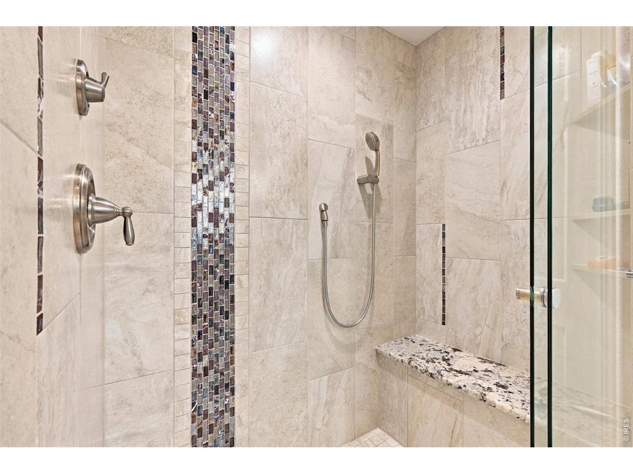 3754 Kentford Road Fort Collins, CO 80525 - Photo 29 of 50 Spa-like tiled shower with beautiful glass tile accents, handheld + overhead shower & granite bench