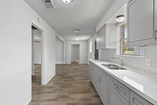a kitchen with stainless steel appliances granite countertop a sink and a refrigerator