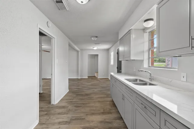 a kitchen with stainless steel appliances granite countertop a sink and a refrigerator