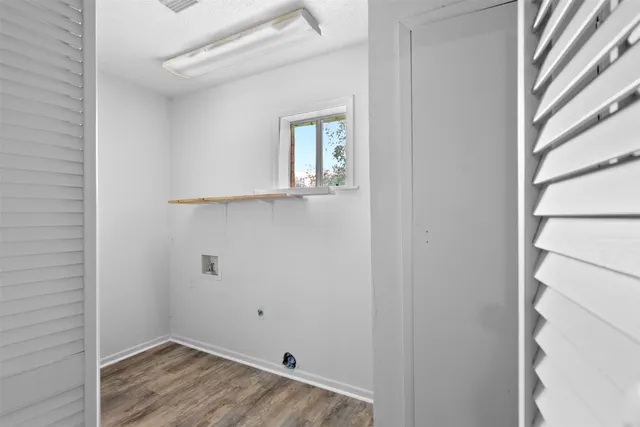 a view of small space with wooden floor and windows