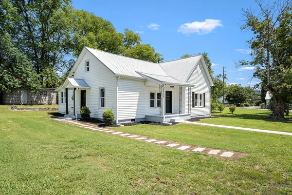 a front view of a house with a yard