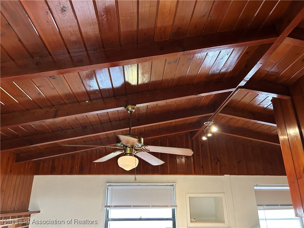 11 Mockingbird Road Lake Placid, FL 33852 - Photo 11 of 41 VARNISHED TONGUE AND GROOVE CATHEDRAL CEILINGS WITH EXPOSED BEAMS OF SOLID WOOD. CEILING FAN AND LIGHT COMPLIMENT THE BRICK FIREPLACE.