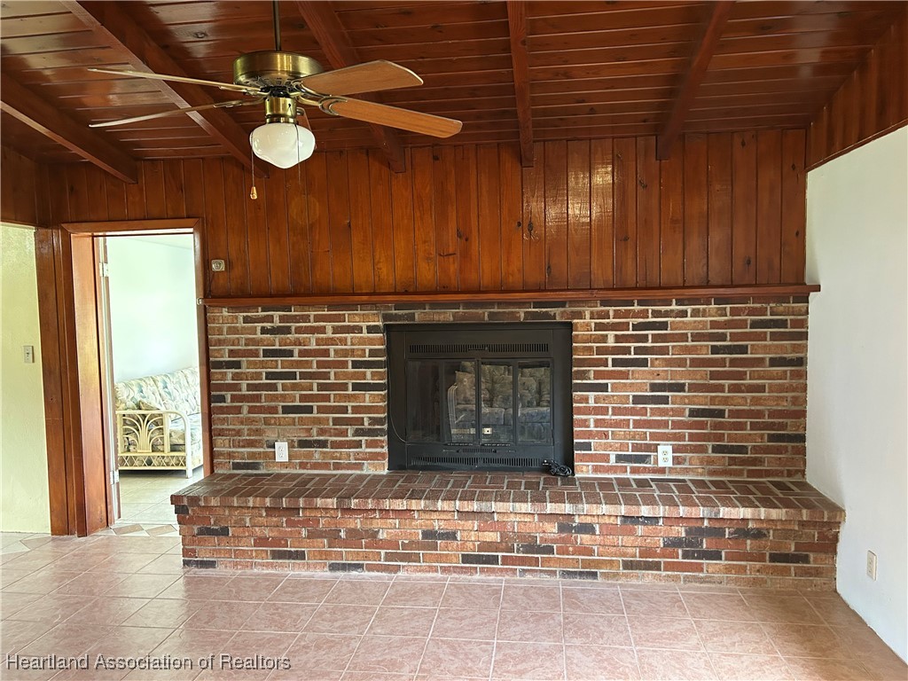 11 Mockingbird Road Lake Placid, FL 33852 - Photo 8 of 41 THE FAMILY ROOM IS WELL APPOINTED WITH A BRICK FIREPLACE AND CATHEDRAL CEILINGS CONSTRUCTED OF VARNISHED TONGUE N GROOVE WITH EXPOSED WOOD BEAMS. THIS LARGE FIREPLACE IS PRESENTLY INOPERABLE. IT WAS PREVIOUSLY OPERATED WITH A GAS HOOKUP!