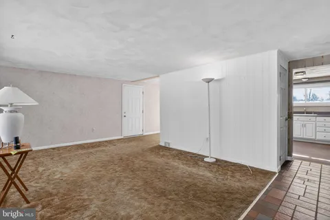 a view of a kitchen with wooden floor and a kitchen