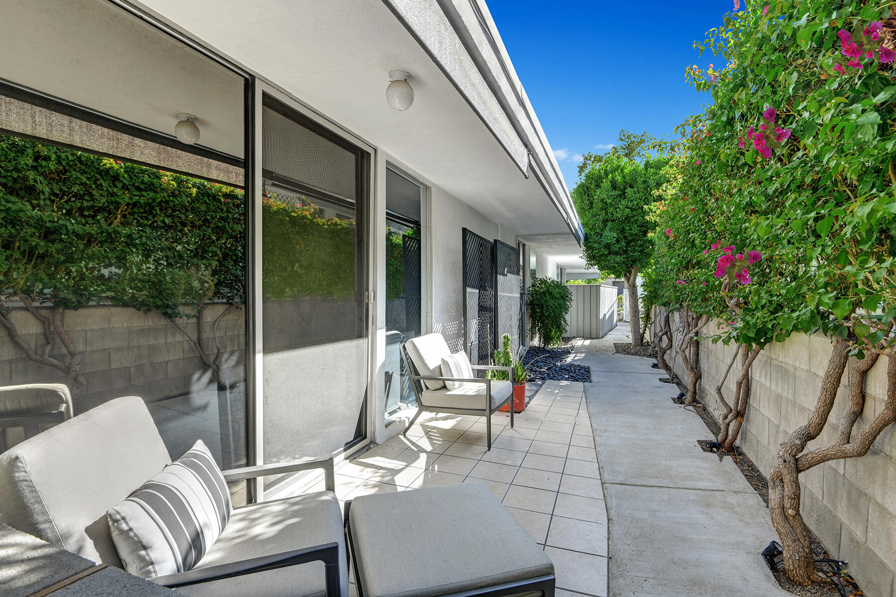 42379 Rancho Las Palmas Drive, Unit 29 Rancho Mirage, CA 92270 - Photo 20 of 24 a view of a patio with couches table and chairs and potted plants