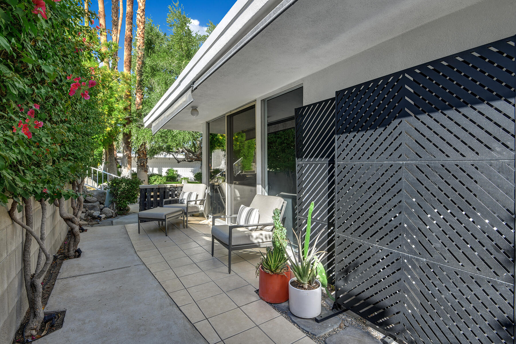 42379 Rancho Las Palmas Drive, Unit 29 Rancho Mirage, CA 92270 - Photo 2 of 24 a view of a patio with couches and potted plants