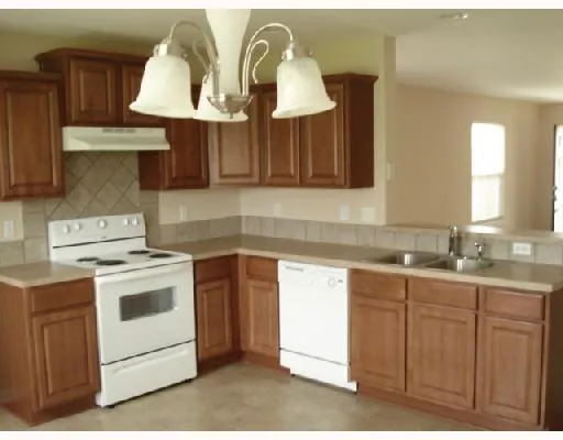 a kitchen with cabinets and appliances