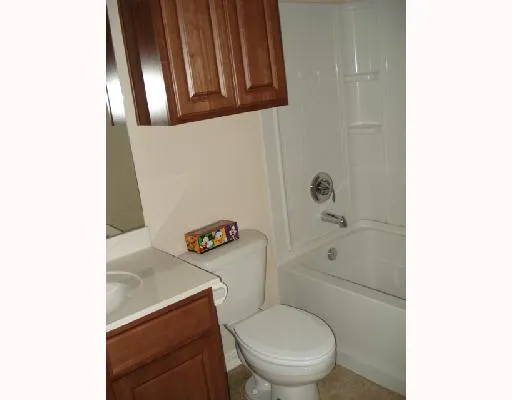 a white toilet sitting next to a bathroom sink and vanity