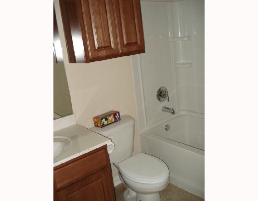 1122 Livermore Street Portland, TX 78374 - Photo 4 of 10 a white toilet sitting next to a bathroom sink and vanity