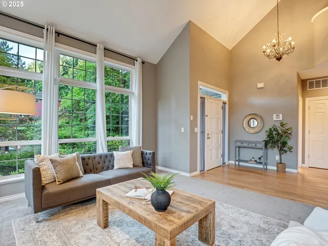 a living room with furniture and a large window