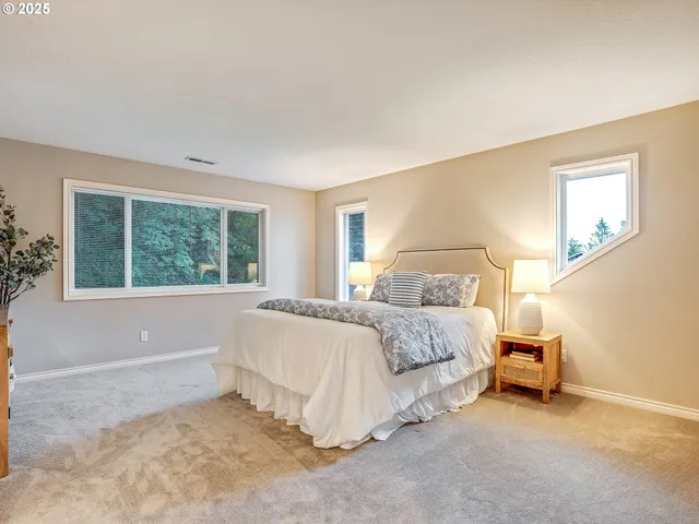 a bedroom with a large bed and a window