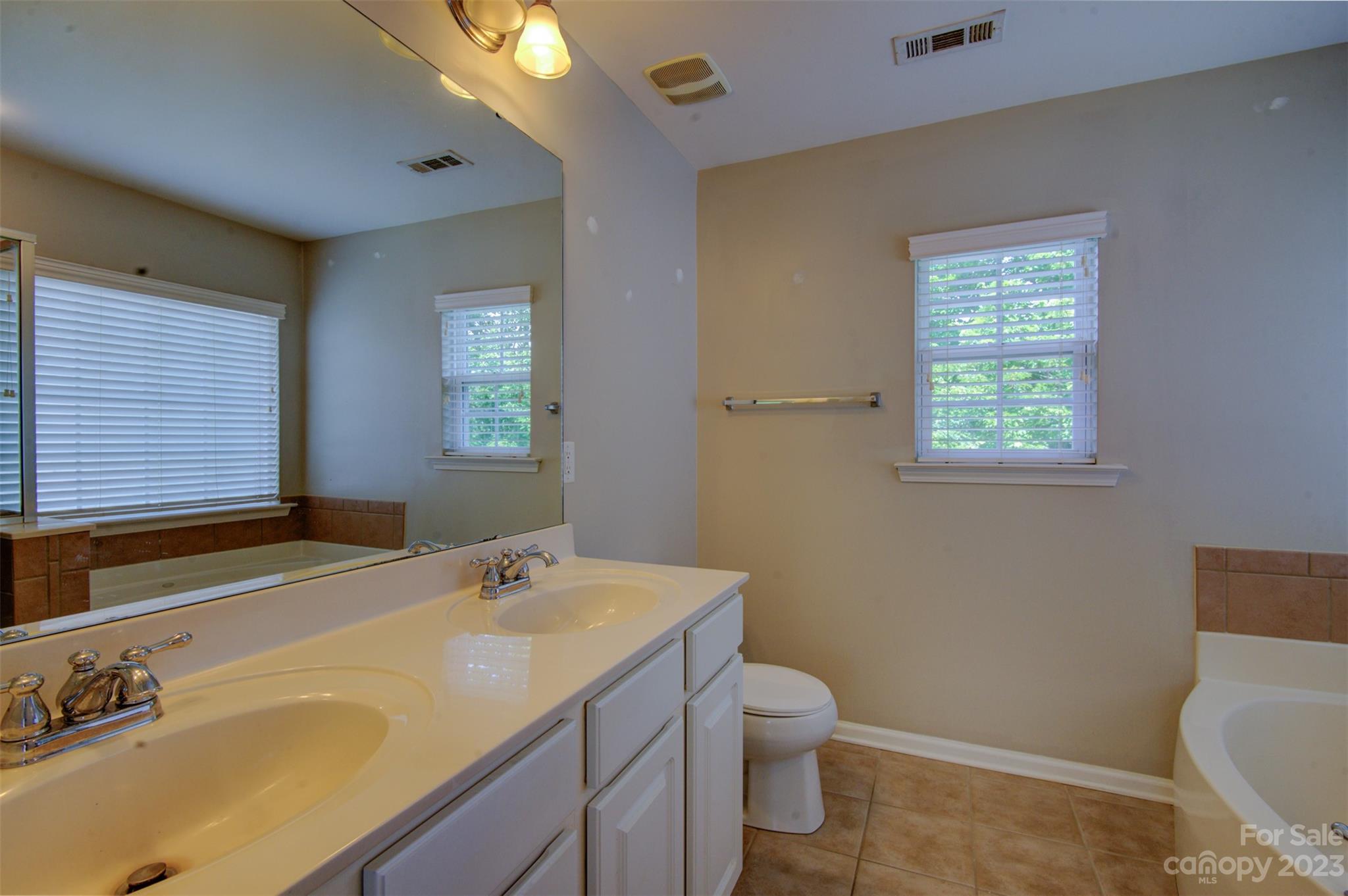 9201 Seamill Road Charlotte, NC 28278 - Photo 16 of 23 a bathroom with a sink toilet and window