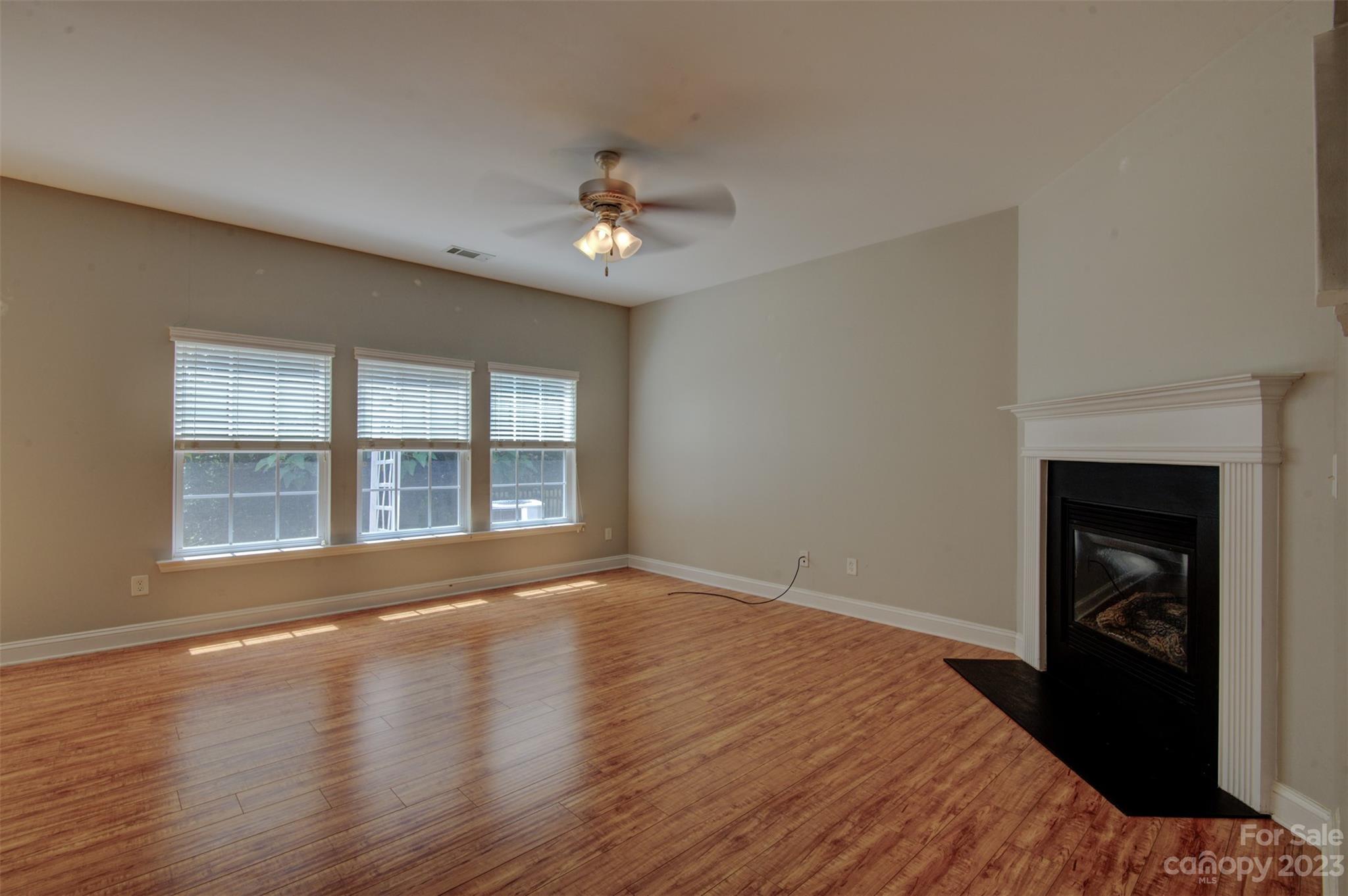 9201 Seamill Road Charlotte, NC 28278 - Photo 2 of 23 a view of empty room with wooden floor and fan
