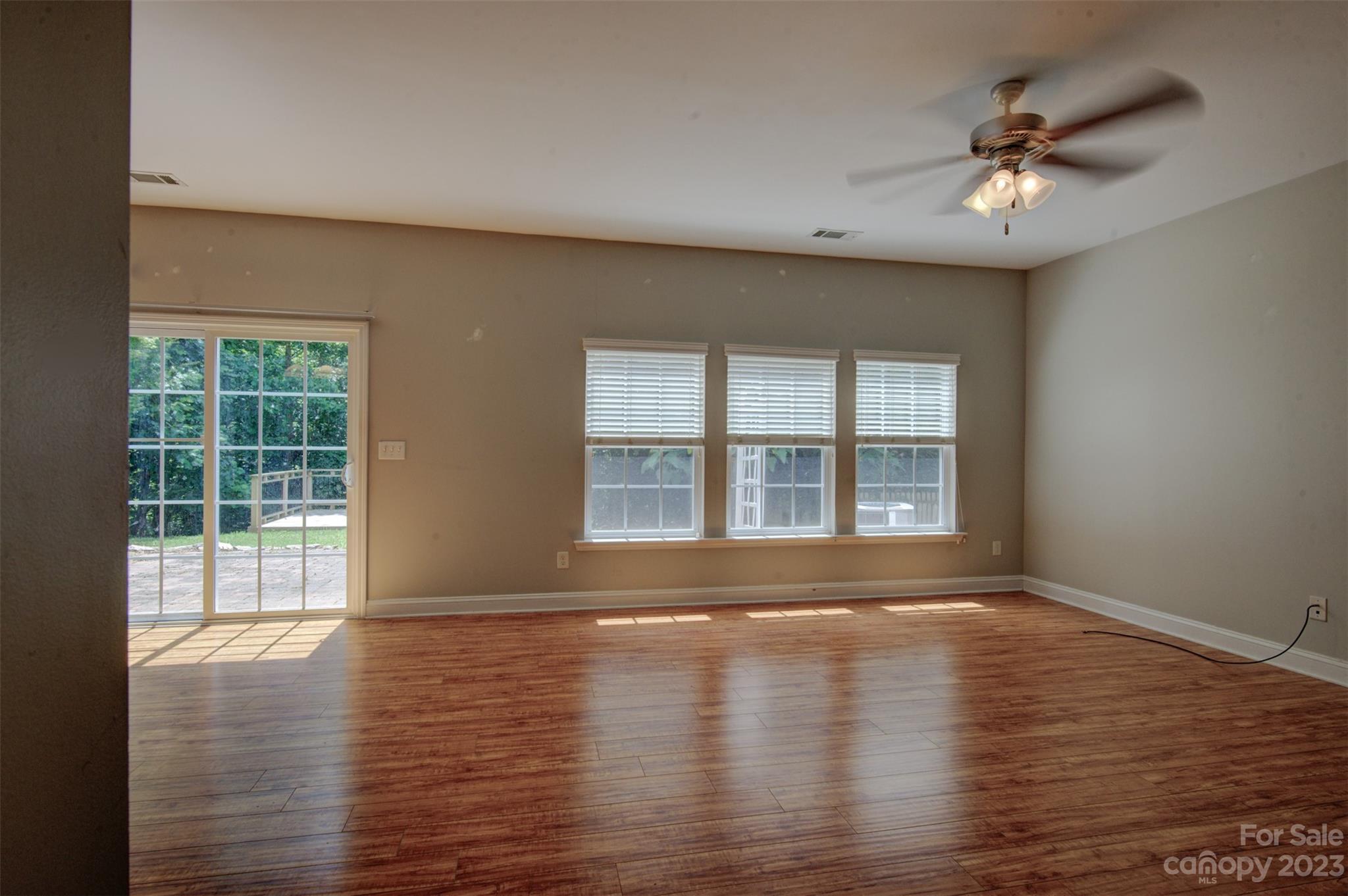 9201 Seamill Road Charlotte, NC 28278 - Photo 3 of 23 a view of an empty room with wooden floor and a window