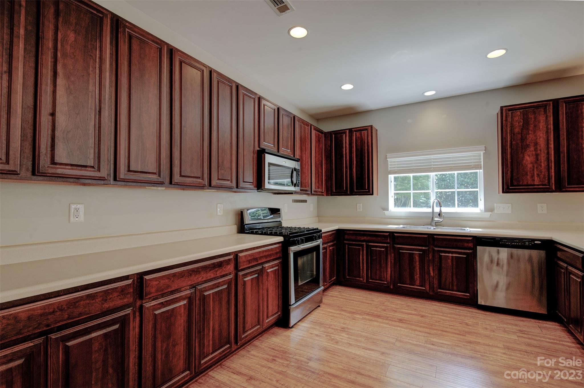 9201 Seamill Road Charlotte, NC 28278 - Photo 6 of 23 a kitchen with stainless steel appliances granite countertop wooden cabinets a sink and dishwasher