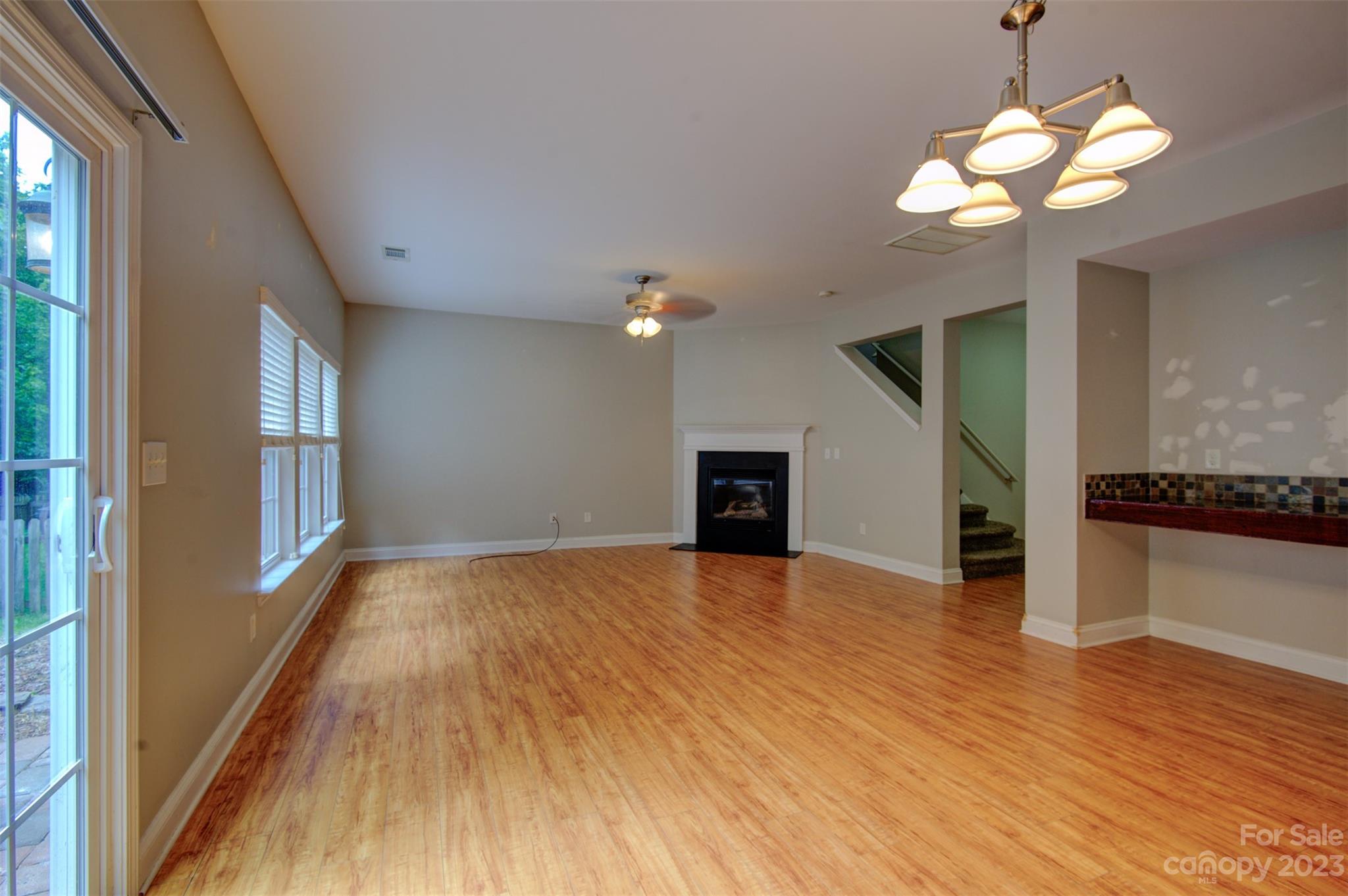 9201 Seamill Road Charlotte, NC 28278 - Photo 10 of 23 a view of an empty room with a window and wooden floor